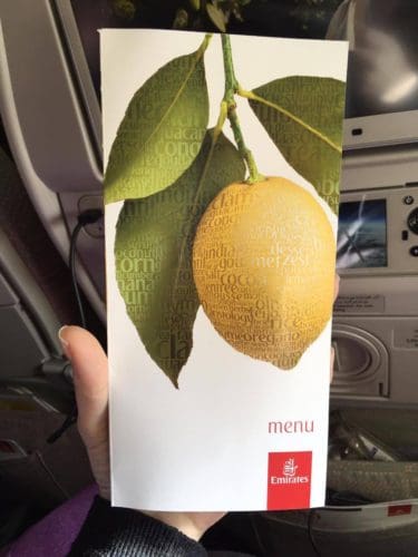 white menu card with a picture of a lemon on the branch and a red Emirates logo in the bottom right