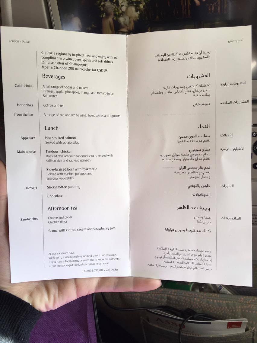 Inside an Emirates economy menu card with Beverages, Lunch and Afternoon Tea headings. English on the left and Arabic on the right