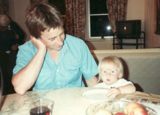 Rosie as a toddler and her dad sitting at a table