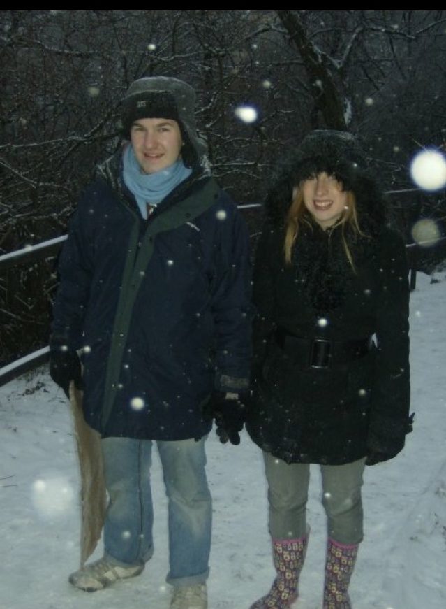 Karl and Rosie walking about wearing winter coats and jeans in the snow in Budapest, Hungary