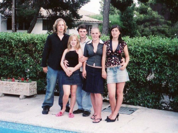 Rosie with 4 friends pose for a photo by the side of a swimming pool