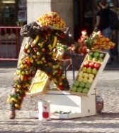 A street perfomer dressed head to toe in fruit in Plaza Mayor, Madrid, Spain