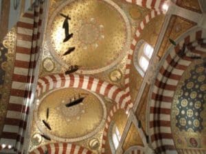 red and white alternating marble arches and a gold cupola of the Basilica of Our Lady of the Guard, Marseille, France