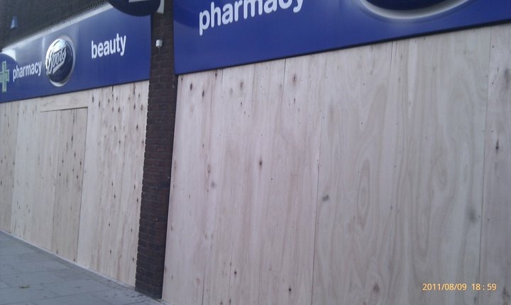Boots Pharmacy storefront boarded up in West Ealing, London