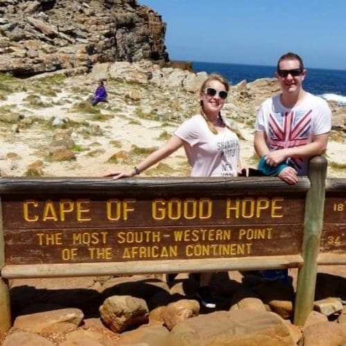 Rosie and Karl pose behind the Cape of Good Hope wooden sign, South Africa