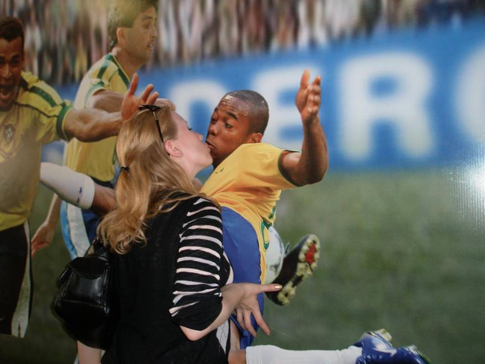 Rosie pretends to kiss a footballers picture at the Maracana Stadium, Rio de Janeiro
