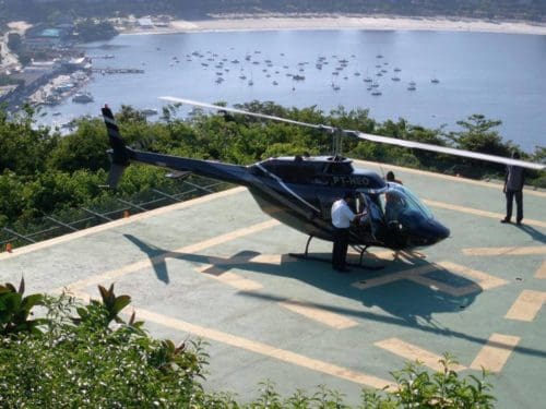 A black tourist helicopter on the pad at Christ the Redeemer, Rio de Janeiro