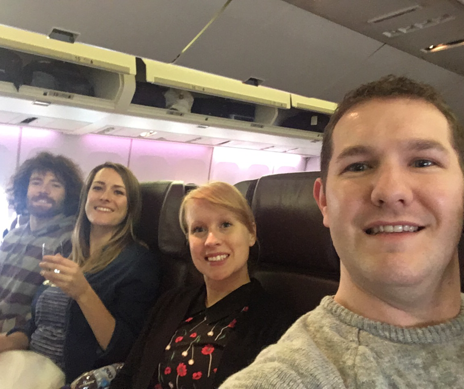 Karl takes a selfie of himself and 3 others sitting on a Virgin Atlantic Boeing 747 Premium Economy