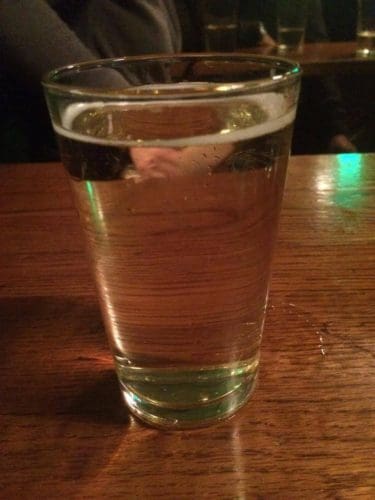 A glass of cider on a pub table