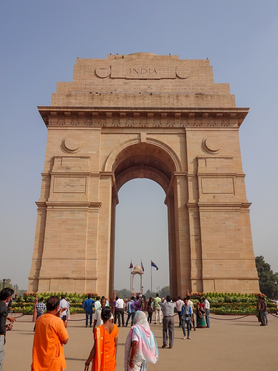 India Gate war memorial with tourists walking around, Delhi, India