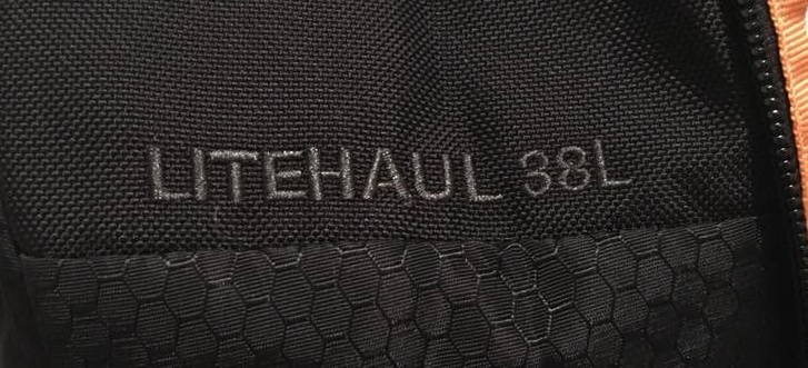 LITEHAUL 38L written in black on a black Kathmandu Litehaul 38L backpack