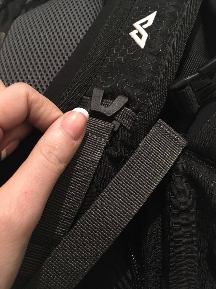 a close up of the bag strap on the black Kathmandu Litehaul 38L backpack