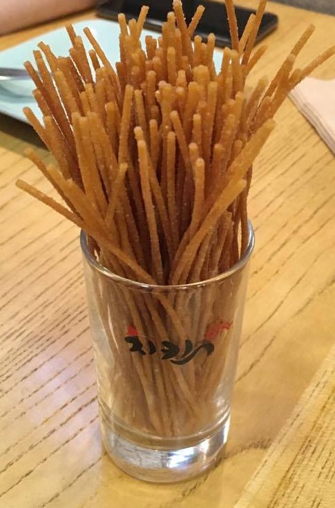 deep fried spaghetti sticks in a glass at Chicken 678 in Seoul, South Korea