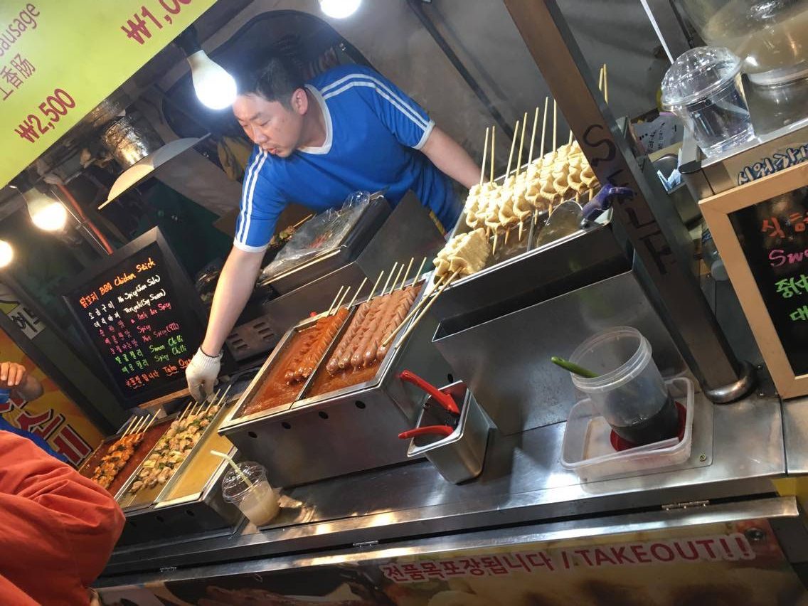 a street food stall selling meat on sticks in Seoul, South Korea
