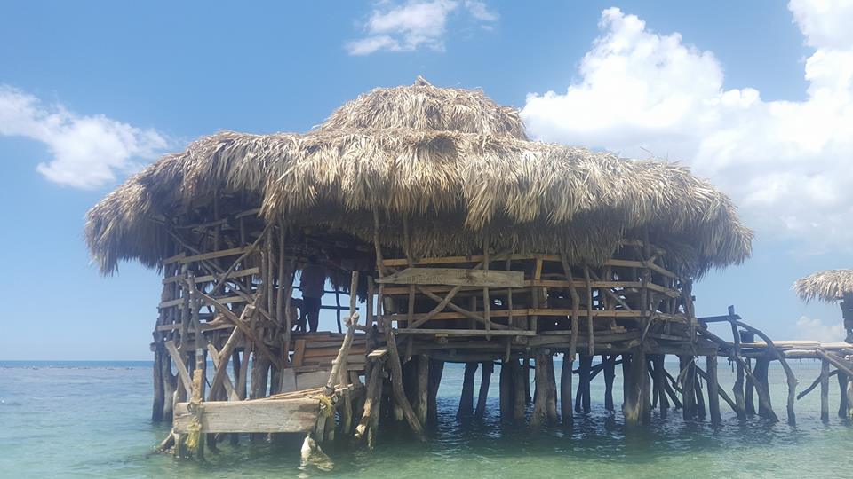 Floyd's Pelican Bar - a wooden floating bar with palm roof in the Caribbean Sea, Jamaica