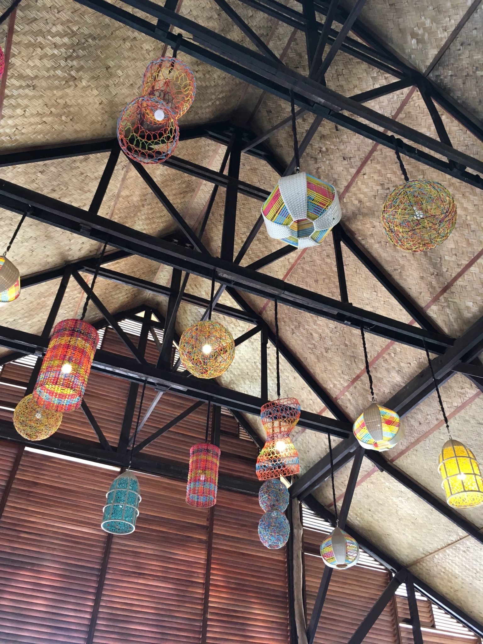 multi-coloured lanterns hang from a vaulted rattan ceiling.