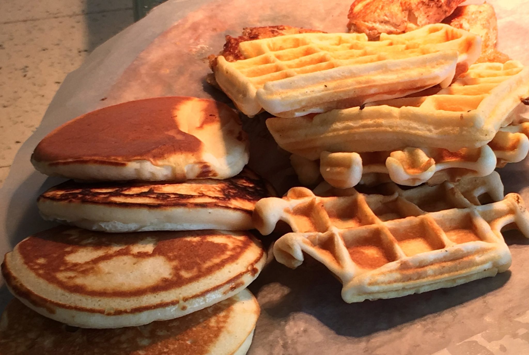 a close-up of a stack of pancakes and waffles