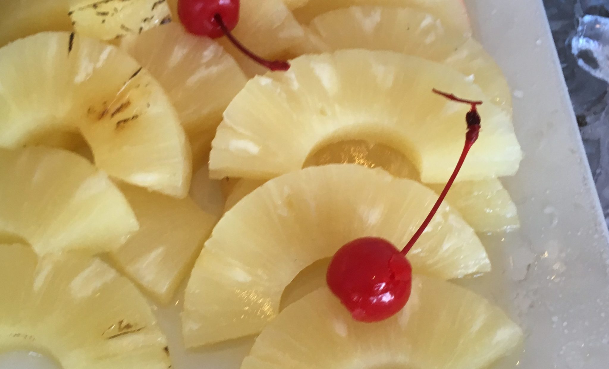 pinapple slices with maraschino cherries