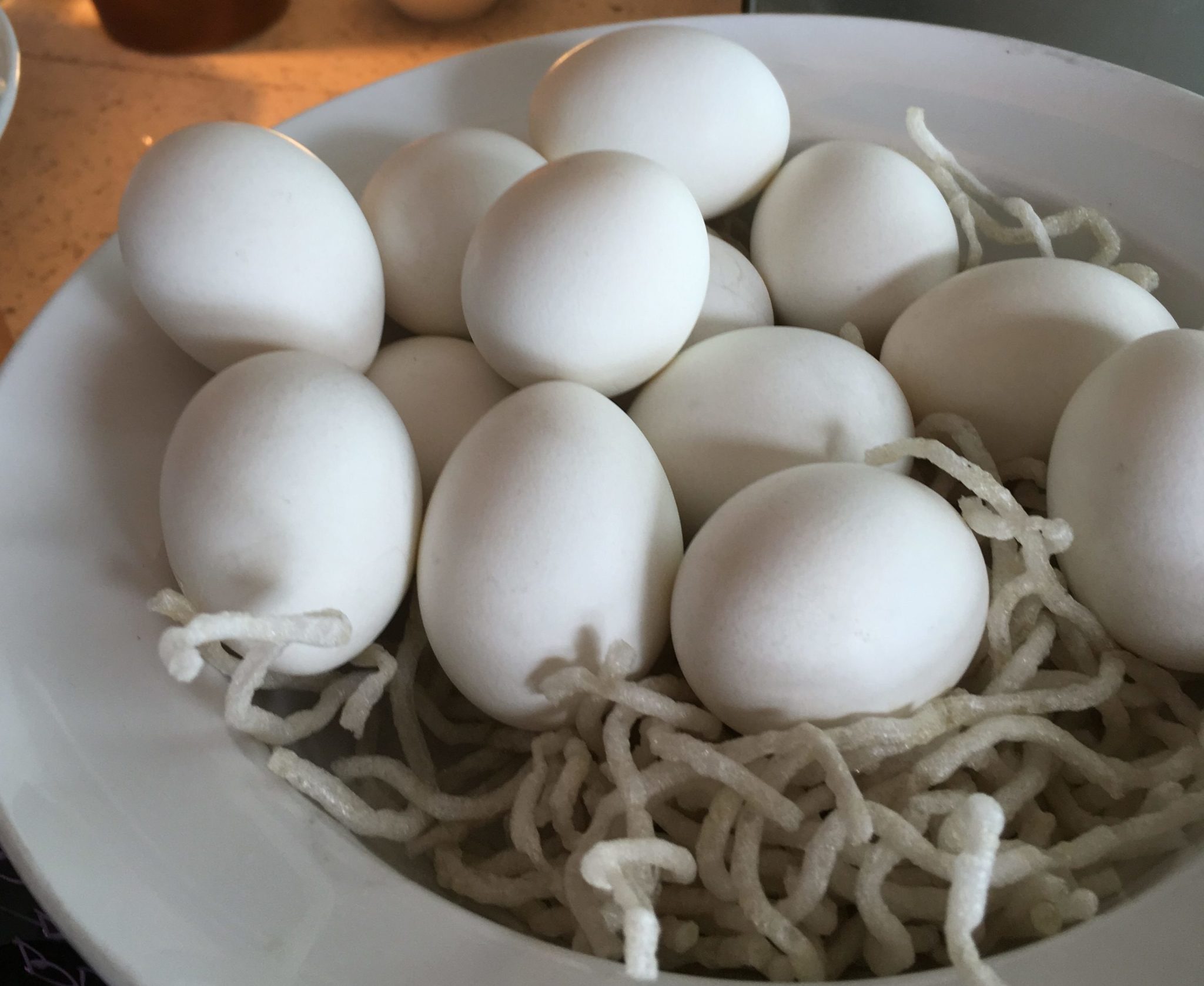 A bowl of several white eggs