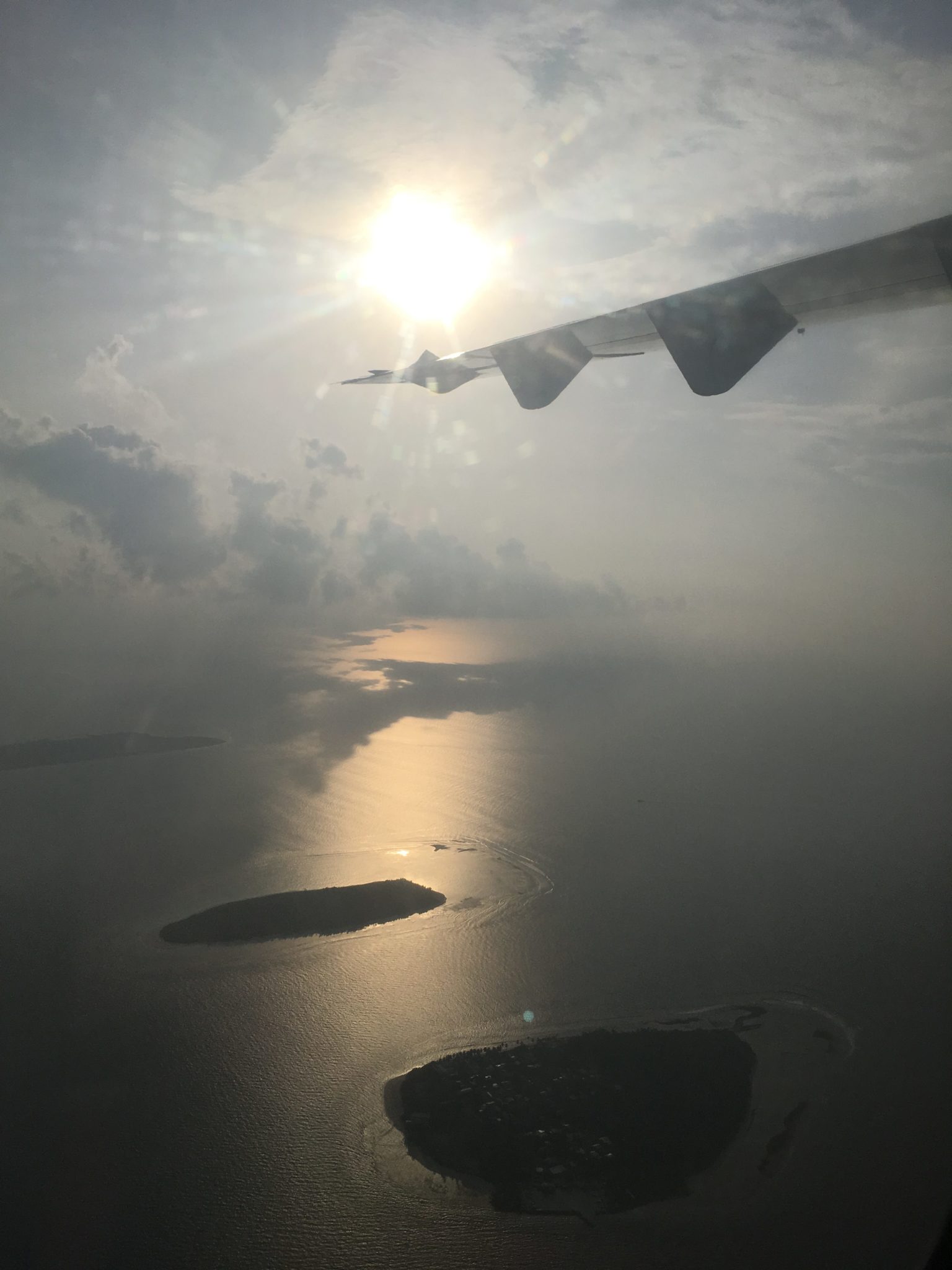 A view from a plane of the Maldives in the morning sun