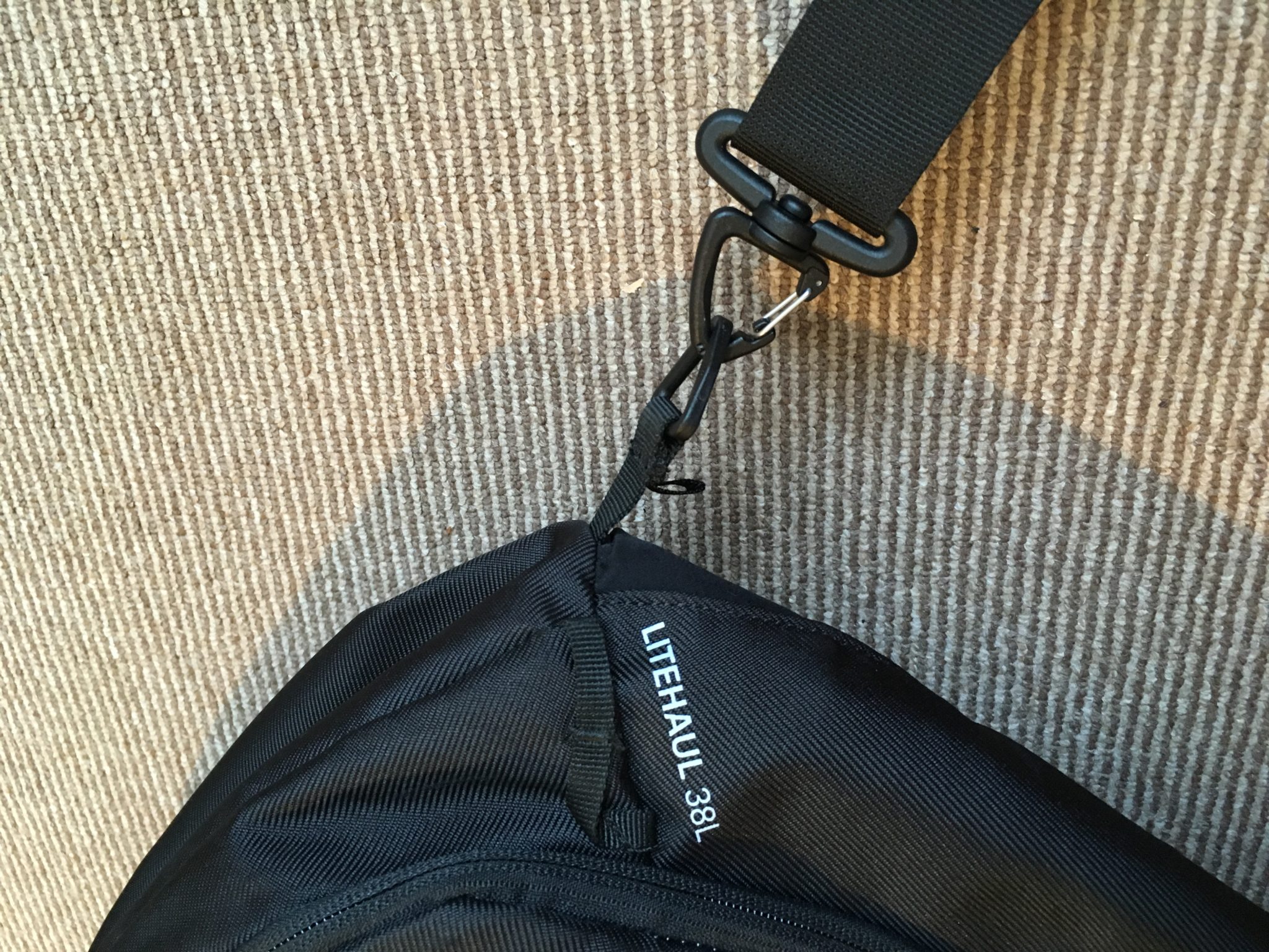 close up of a Kathmandu Litehaul 38L backpack shoulder strap clips