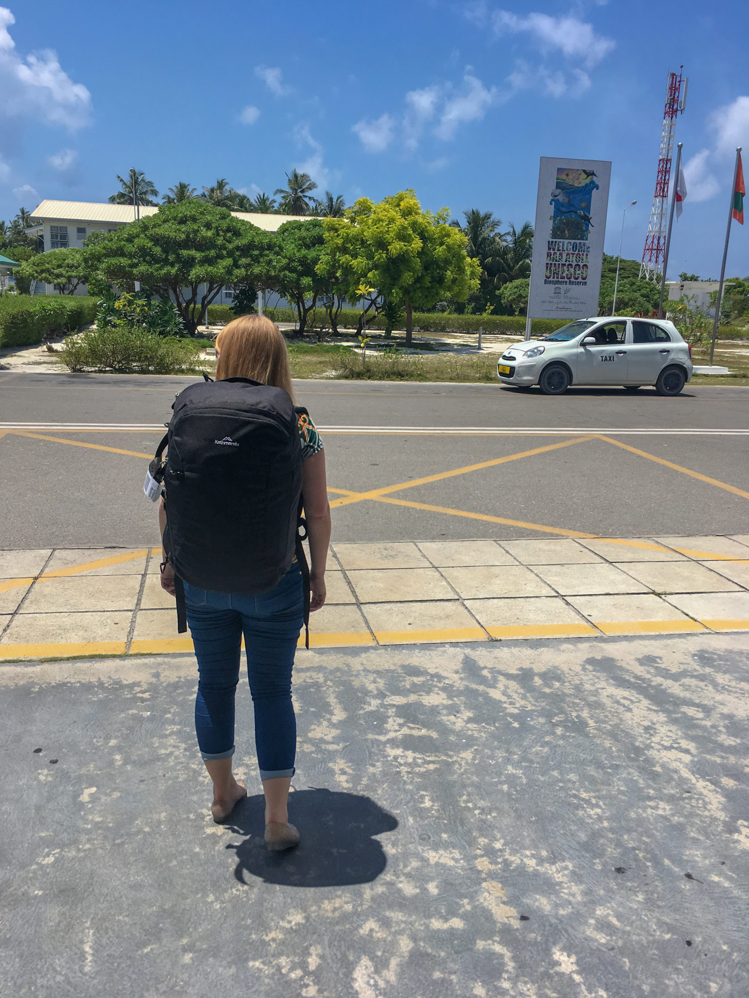 Rosie wearing a black Kathmandu Litehaul 38L backpack in the Maldives