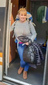 Rosie with her backpack at the door of a Trans-Siberian train