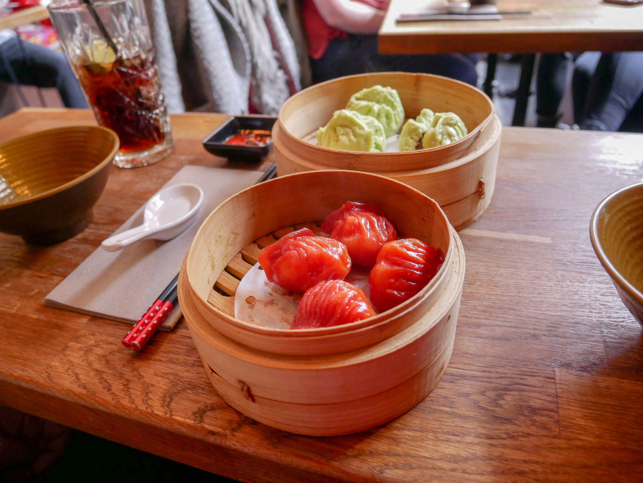 4 "ruby prawn dumplings" and 3 pork buns in wooden baskets at BoaziInn restaurant, Soho, London