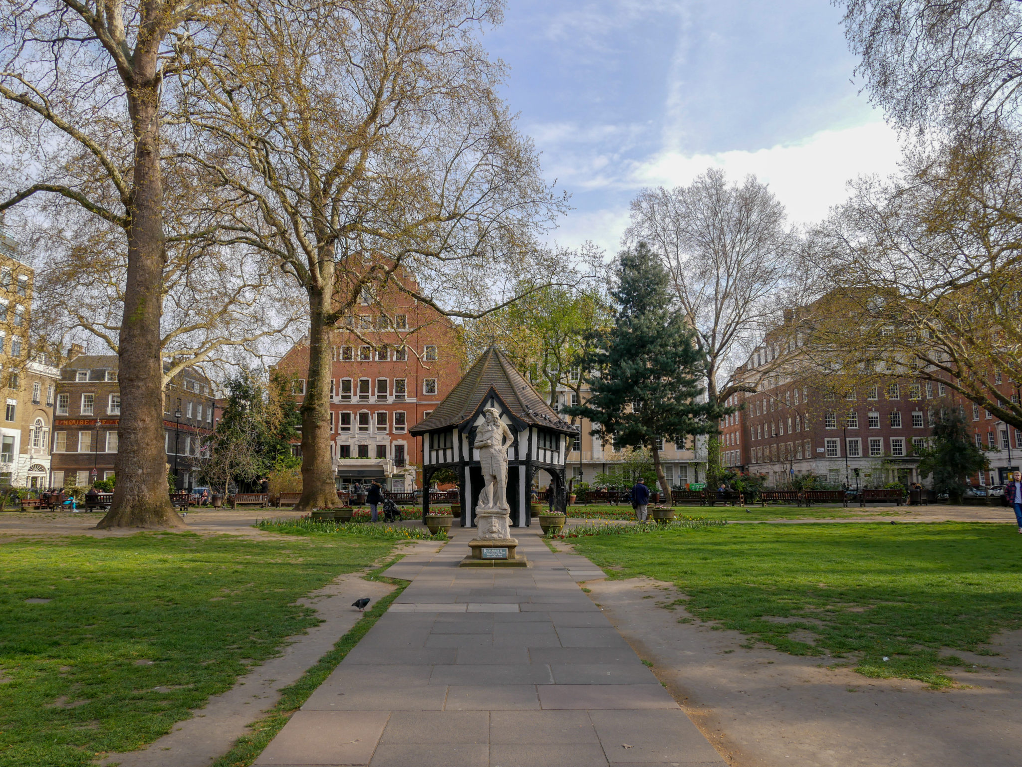 Soho Square Gardens with a statue of Charles II in front of the wooden mock market-cross building, Soho, London