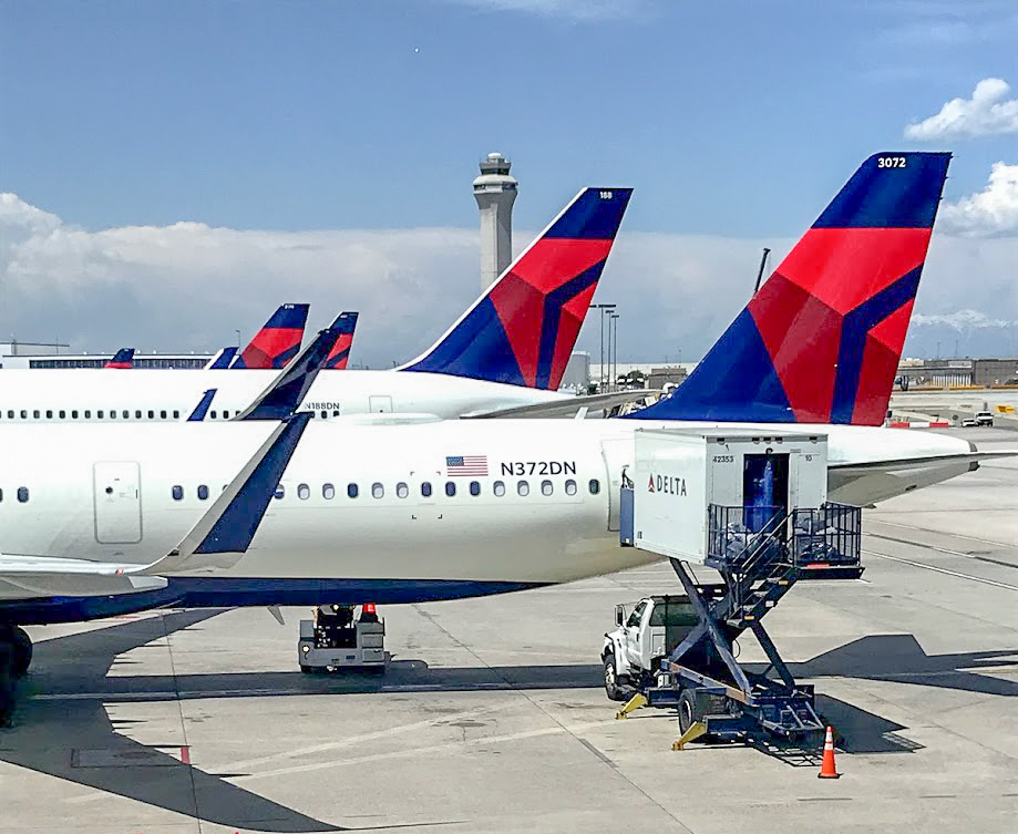 Delta Air Lines Airbus A321-200 plane and other Delta tails behind lined up on stands at Salt Lake City Airport