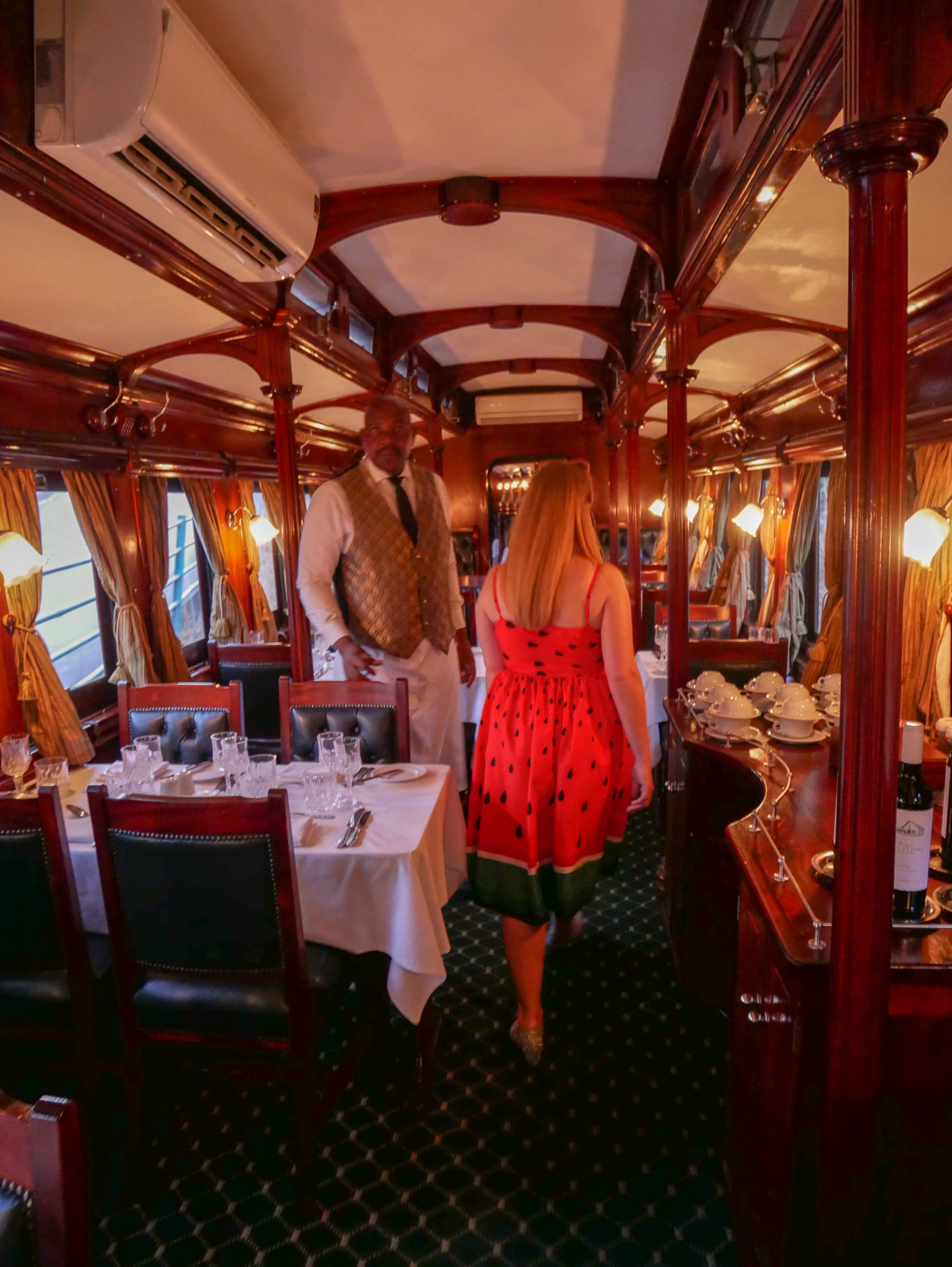 Rosie walks through the Dining Car of the Royal Livingstone Express train
