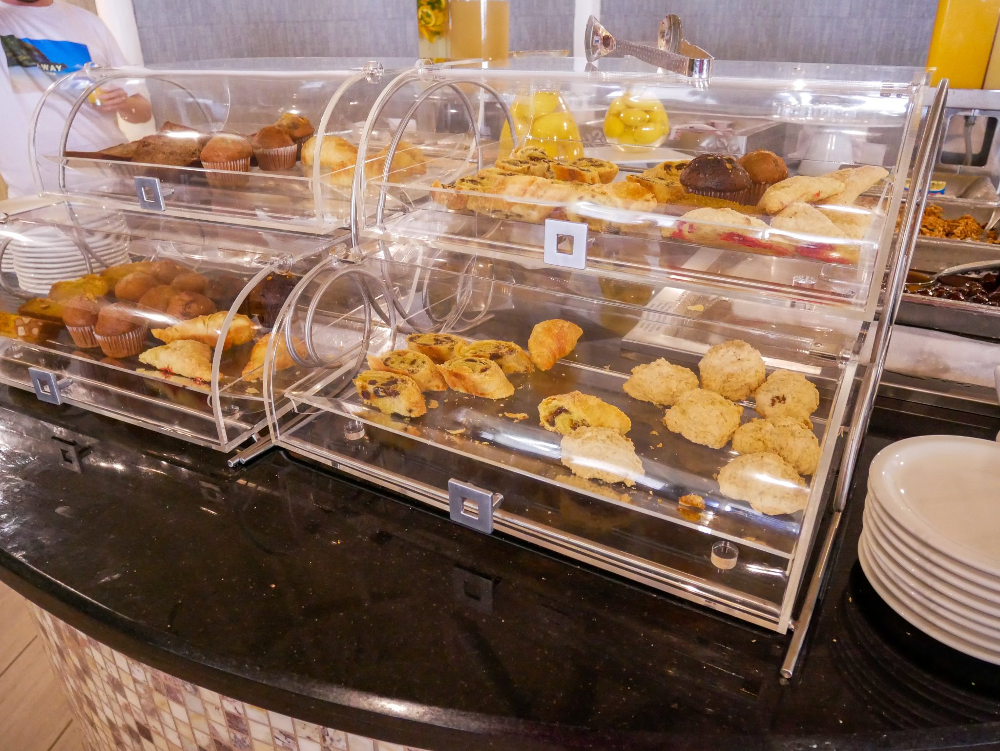 Breakfast pastries in their clear bread bins