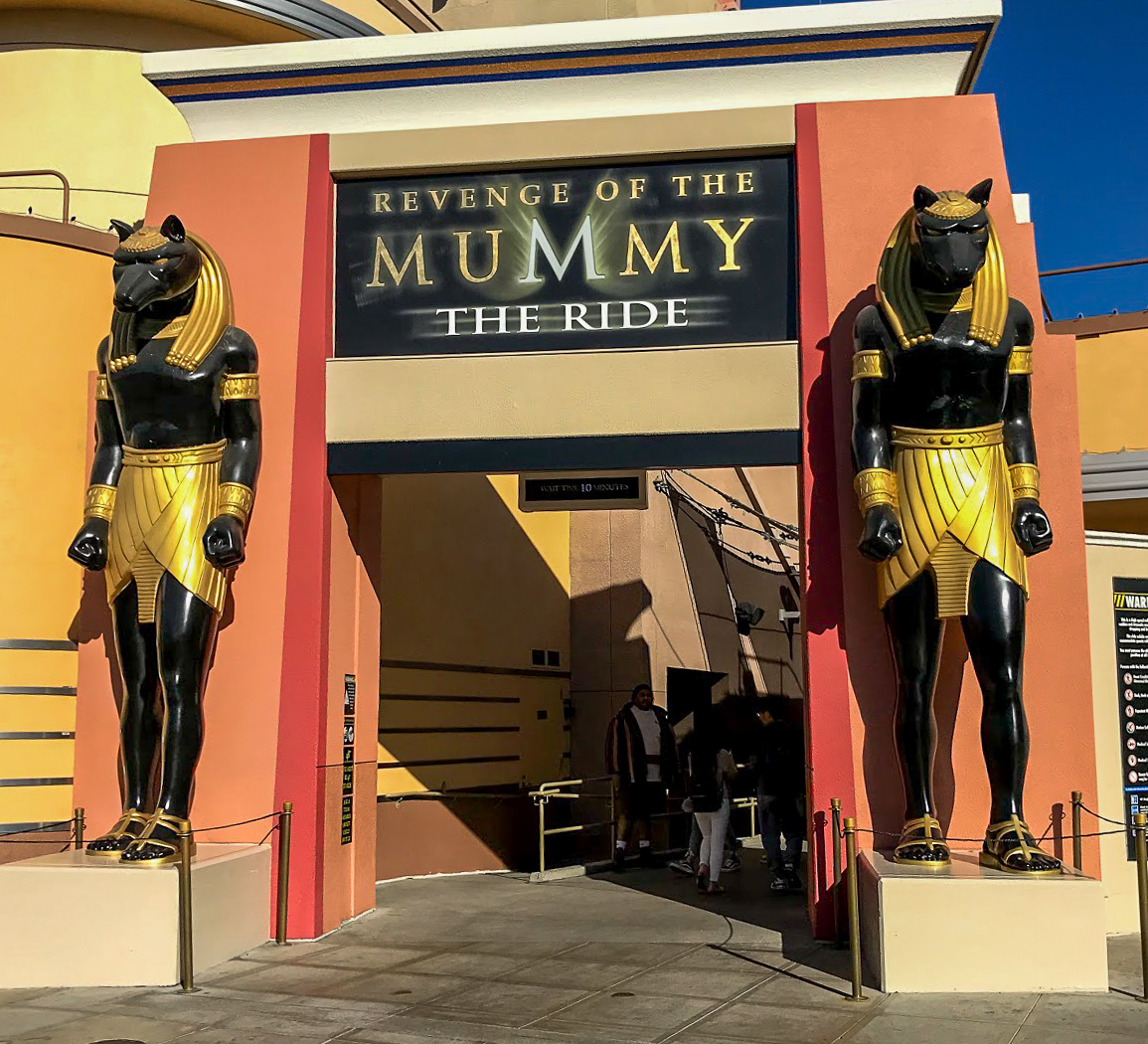 The entrance to Revenge of the Mummy - The Ride, flanked by two big Egyptian statues in Universal Studios Hollywood