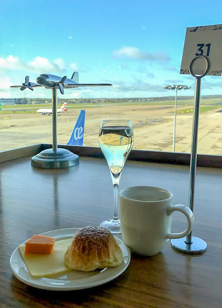 champagne and food by the window, overlooking the runway at No1 Lounge at London Gatwick South Terminal