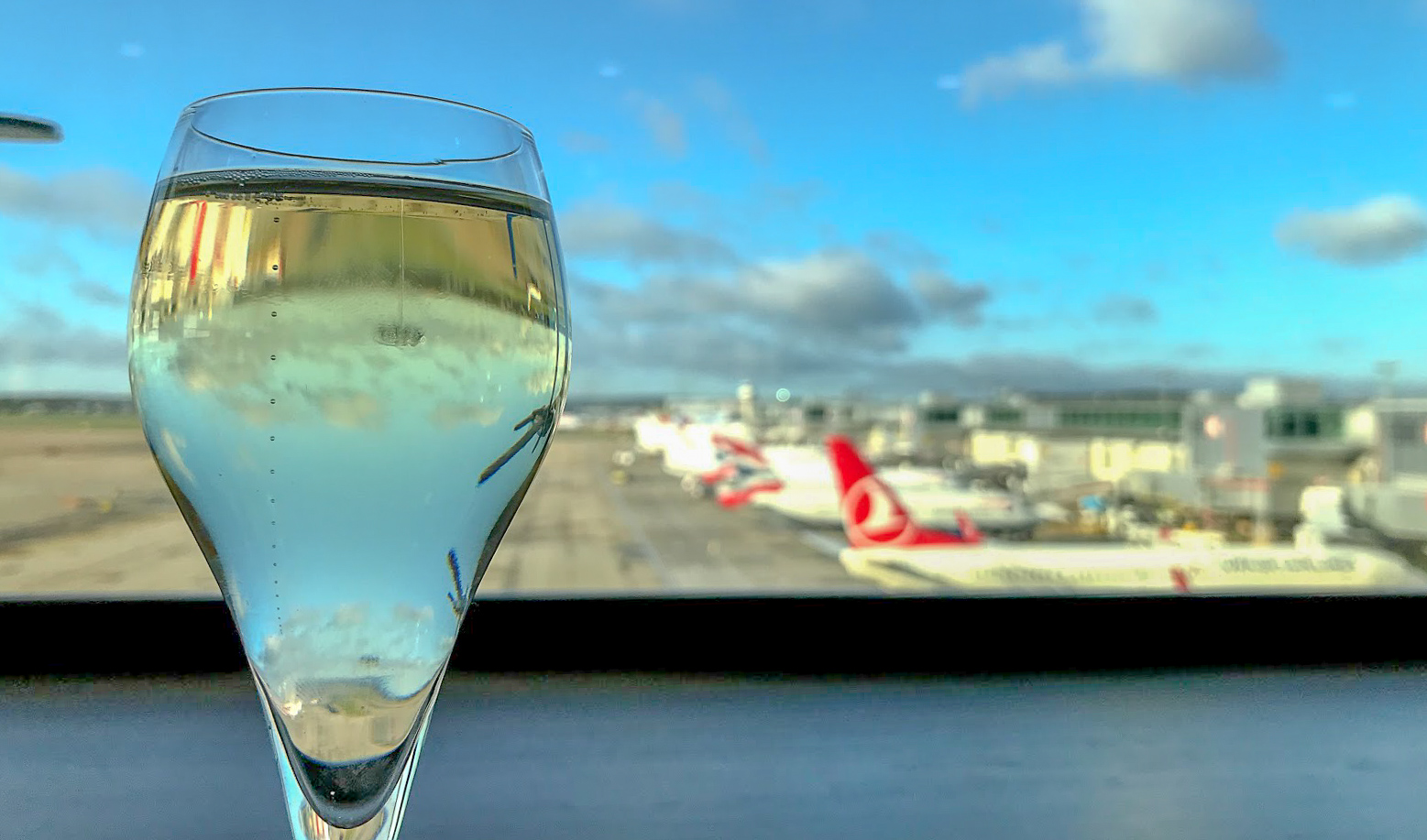 champagne by the window, overlooking planes at No1 Lounge at London Gatwick South Terminal