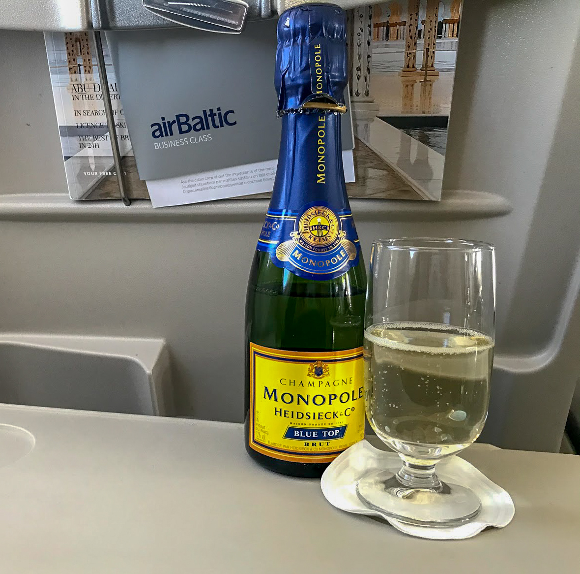 airBaltic A220-300 business class Monopole Brut Champagne bottle and glass