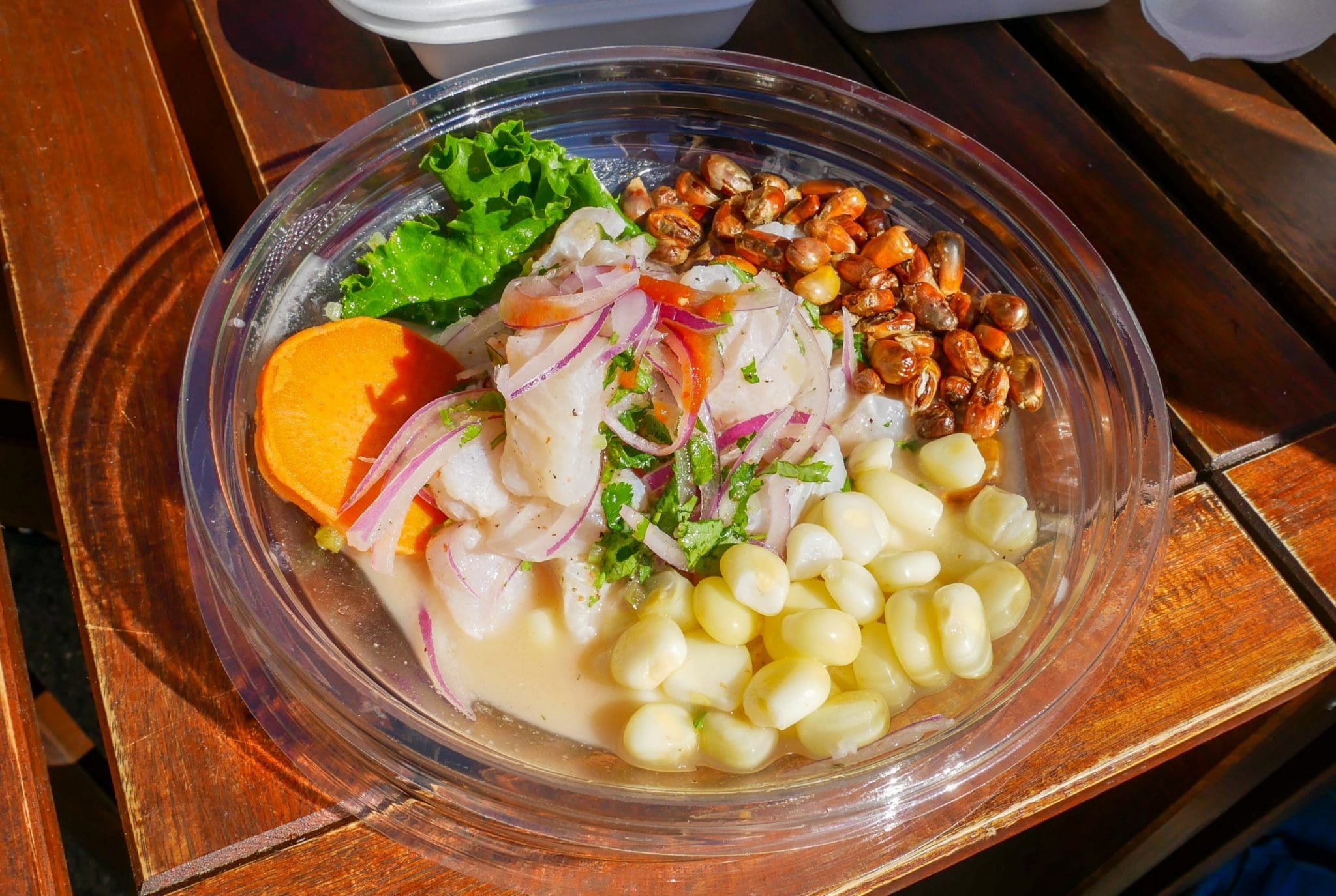white fish ceviche, lupine beans, sweet potato slices and salad