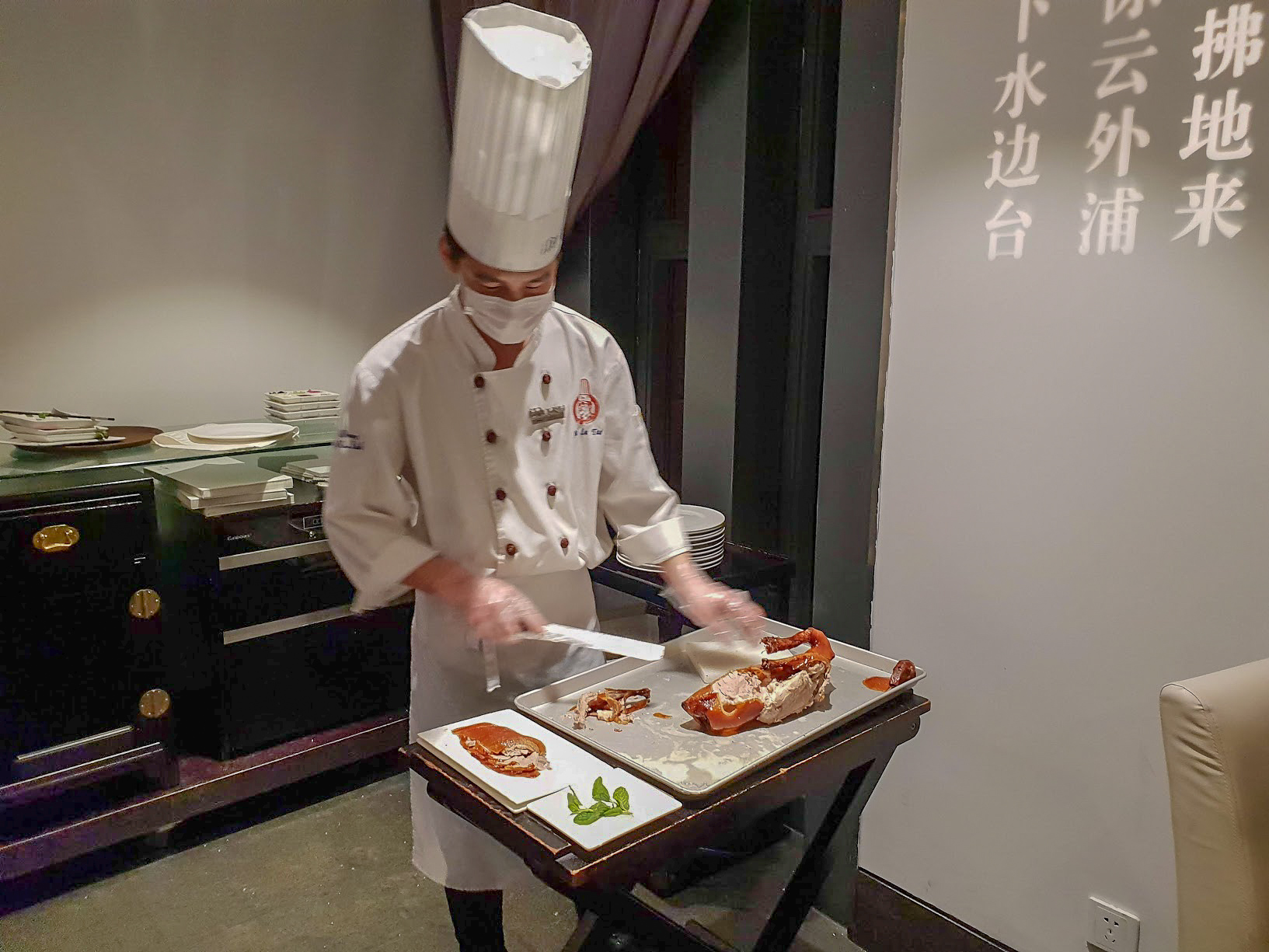 a chef carves Peking Duck in Da Dong Restaurant, Beijing, China