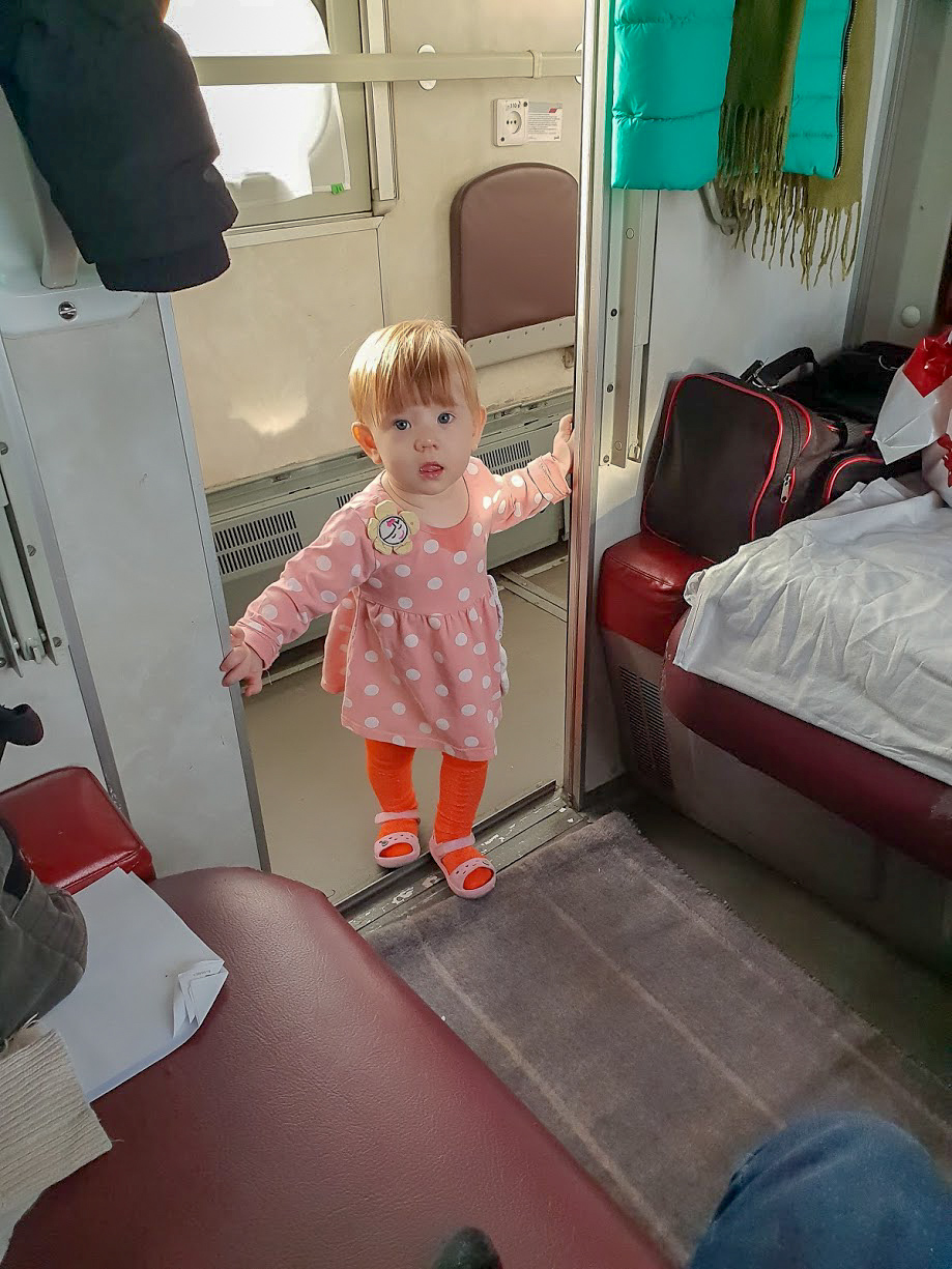 a little girl in a second class coupe of the Trans-Siberian Train
