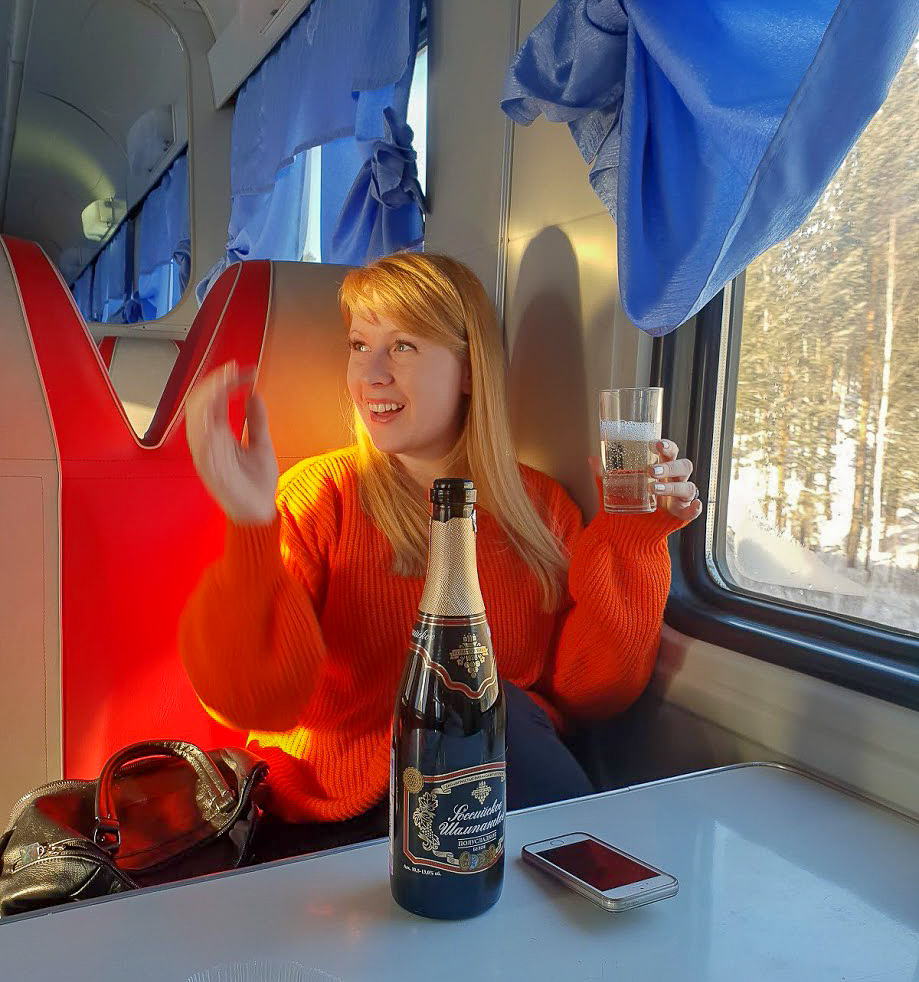 Rosie drinks Champansky in the dining car of a Russian trans-Siberian train