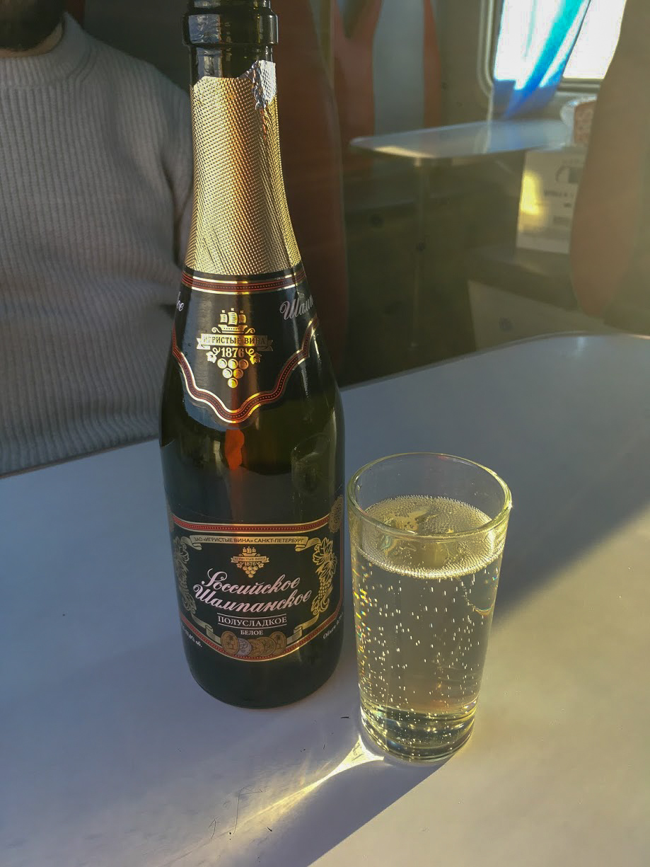 A bottle and glass of Champansky on a table of a Trans-Siberian Train