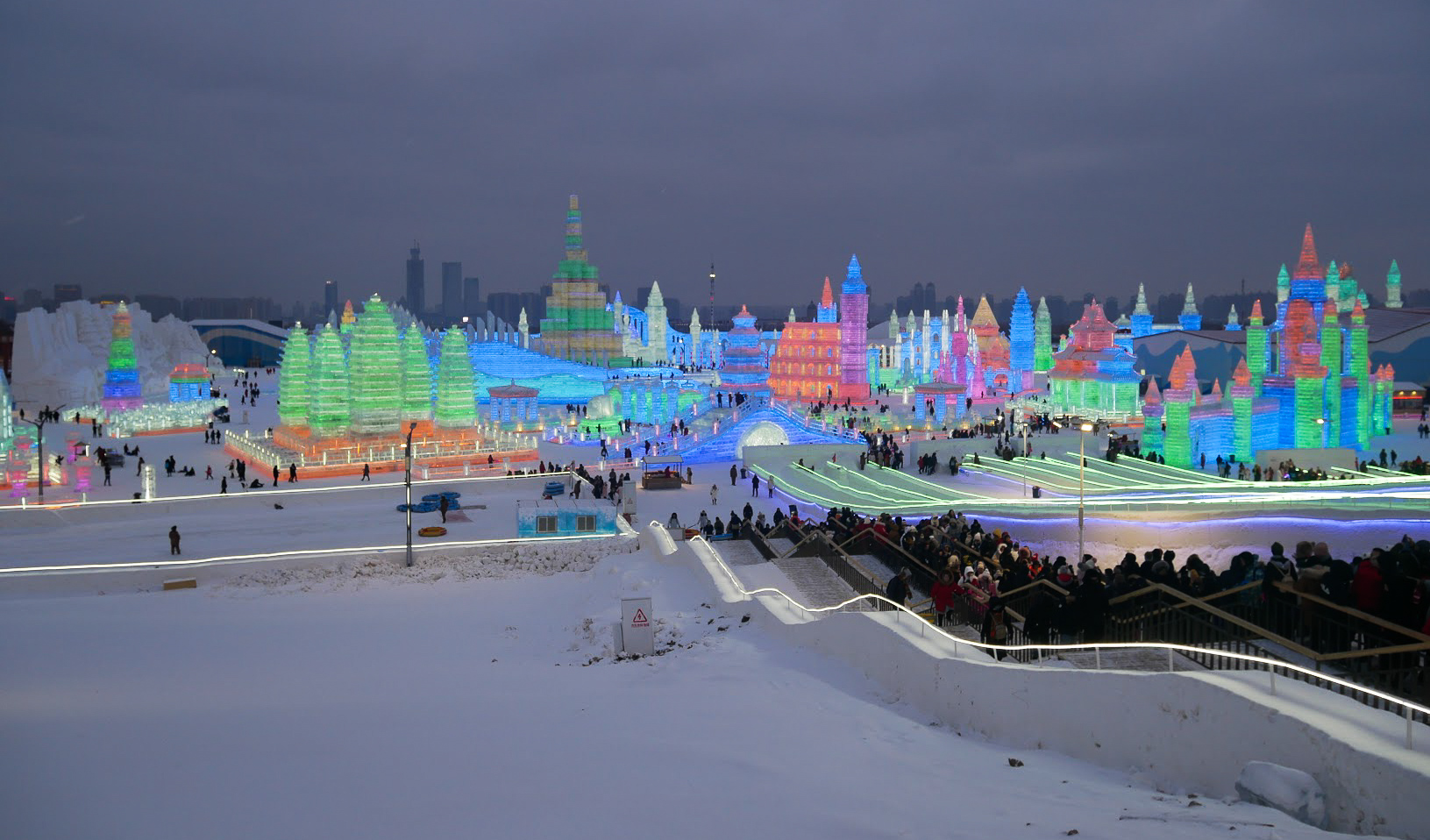 Harbin Ice & Snow Festival in the evening lit up by colourful lights, China