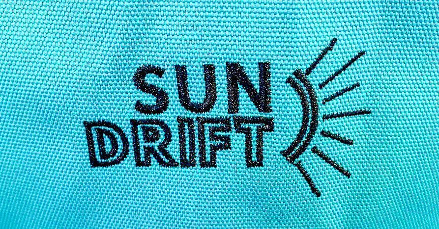 SunDrift Logo stitched on a light blue Panglao 55L Backpack