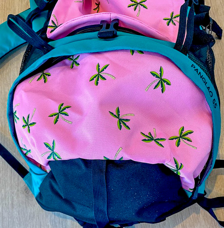 close up view of the palm tree design on the SunDrift Panglao 55L Backpack
