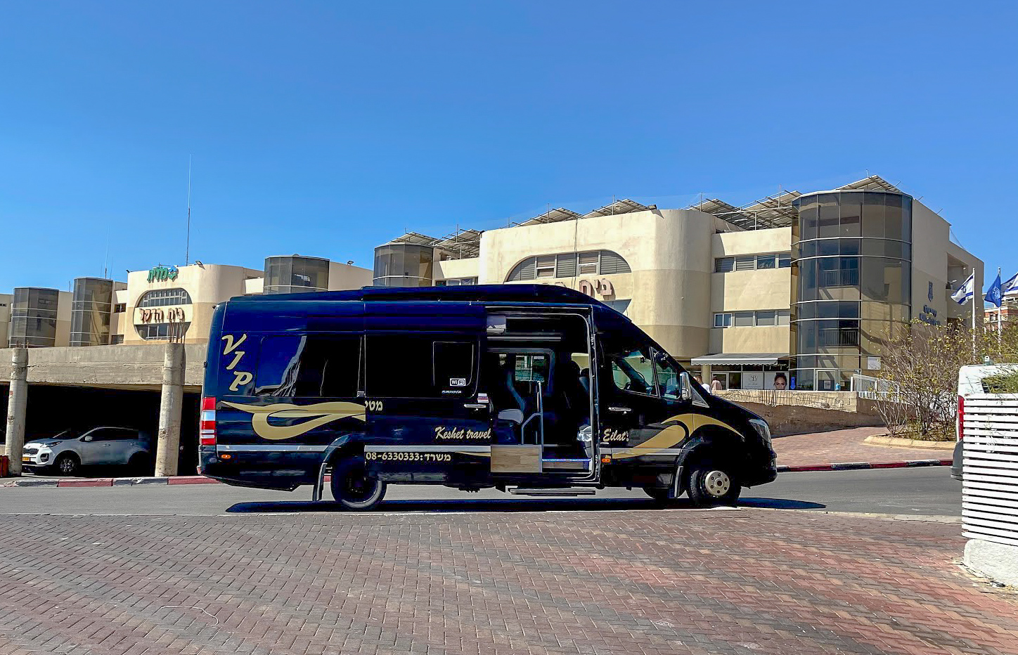 a dark blue minibus with VIP in gold writing in Eilat, Egypt