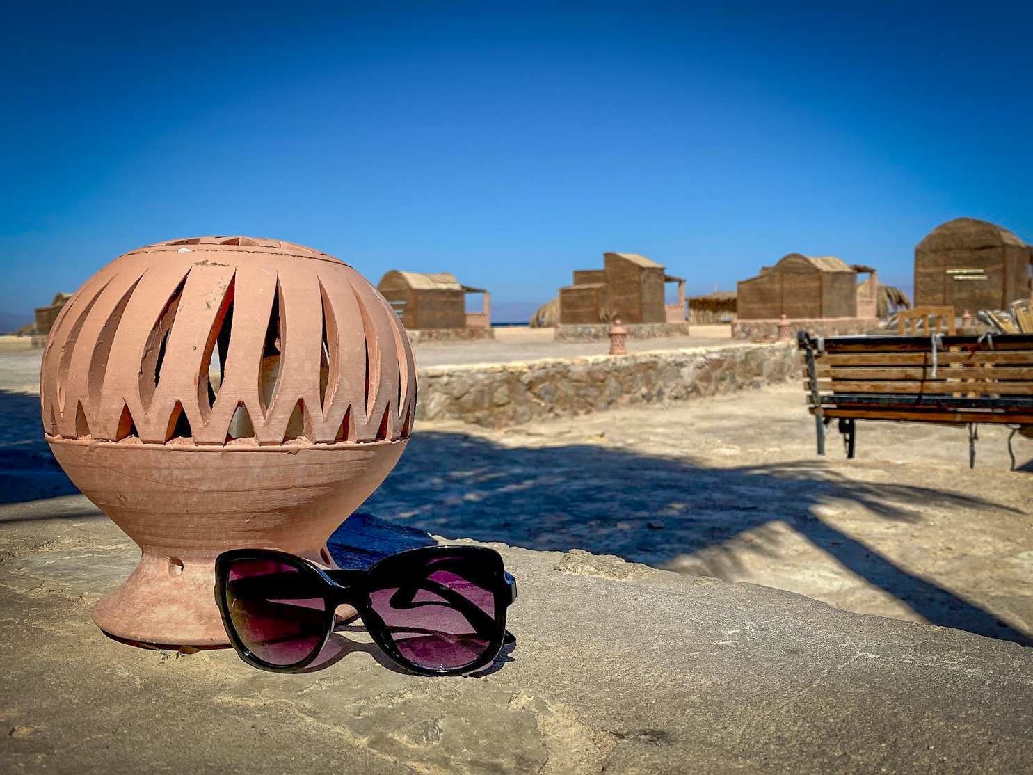 sunglasses propped next to a clay sphere lantern at Aqua Sun, Gulf of Aqaba, Egypt