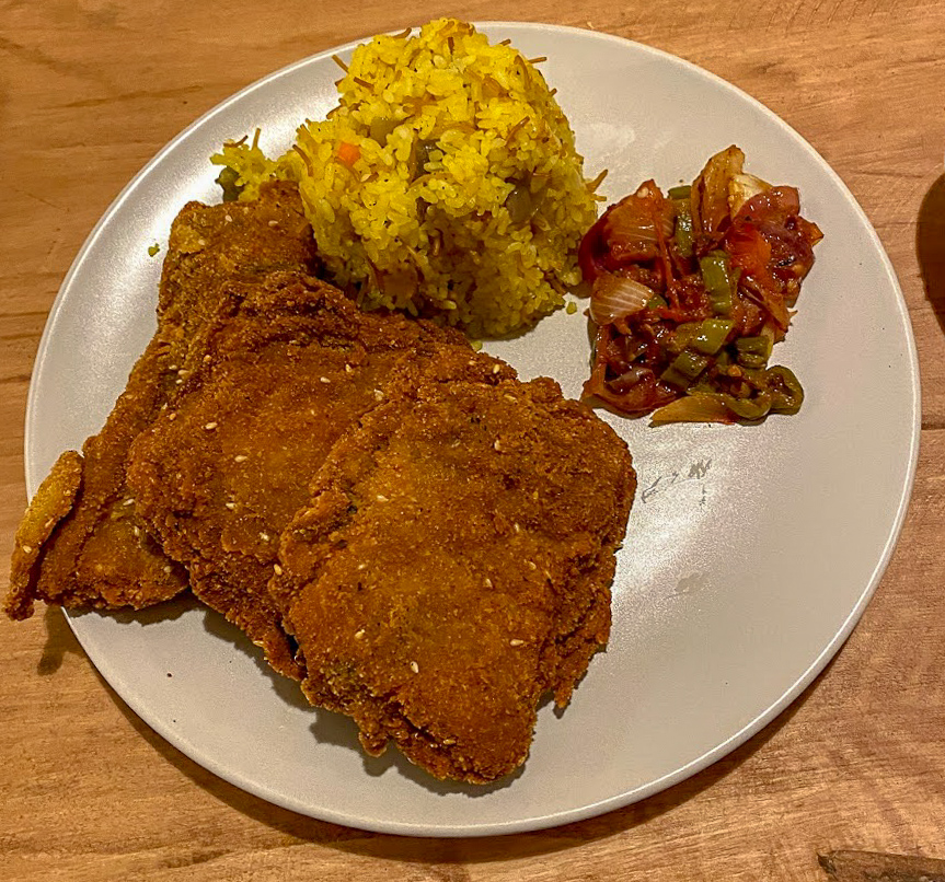 breaded fish and yellow rice on a plate at Aqua Sun, Gulf of Aqaba, Egypt