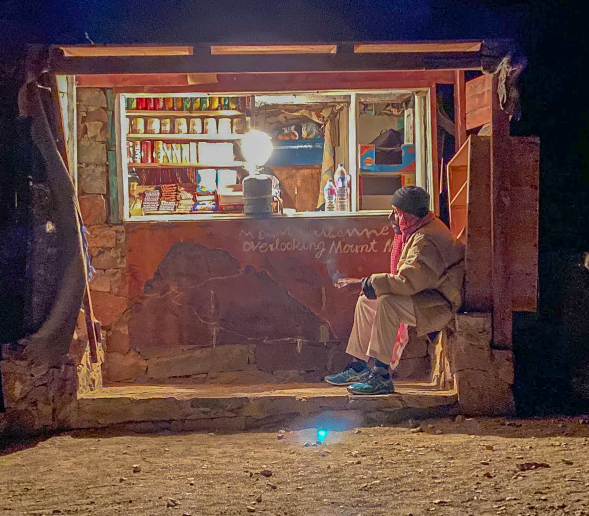 A small stone shop lit by a gas lamp on Mount Sinai, Egypt