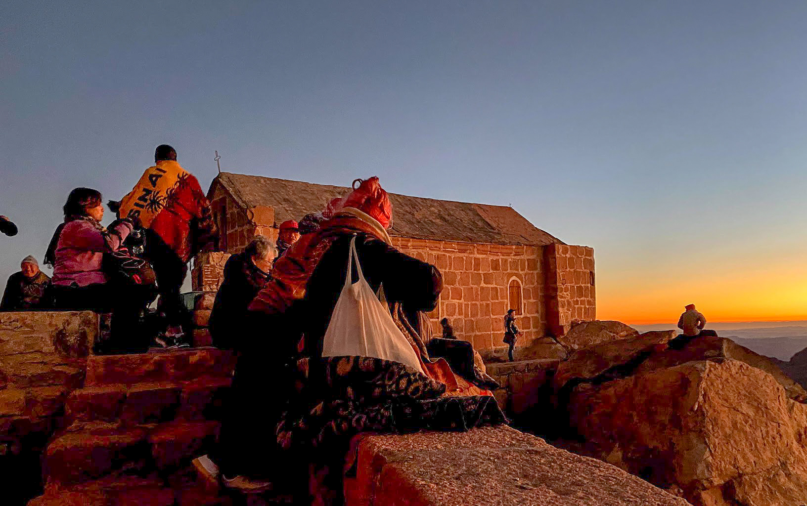 Walkers watching the sunrise from Mount Sinai, Egypt