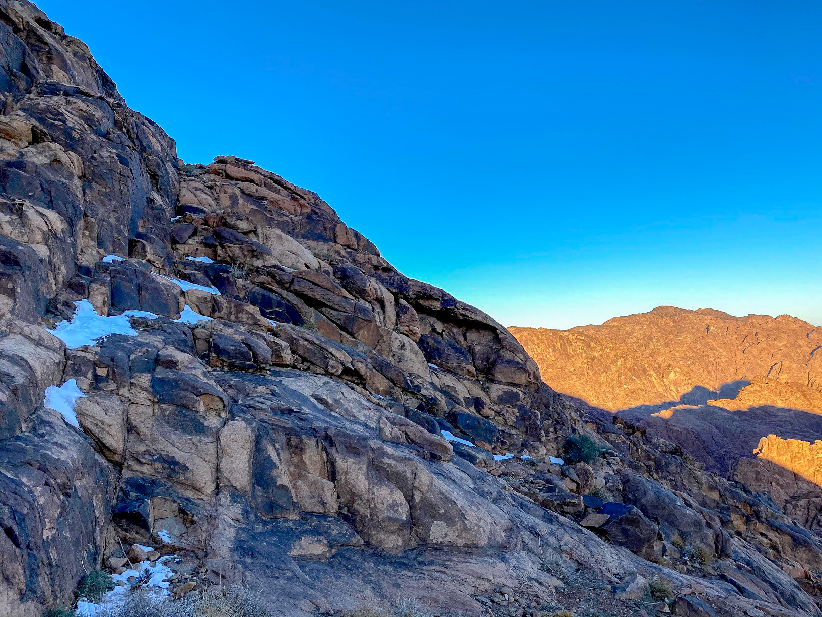 Ice on the rocks of Mount Sinai, Egypt against a clear blue sky